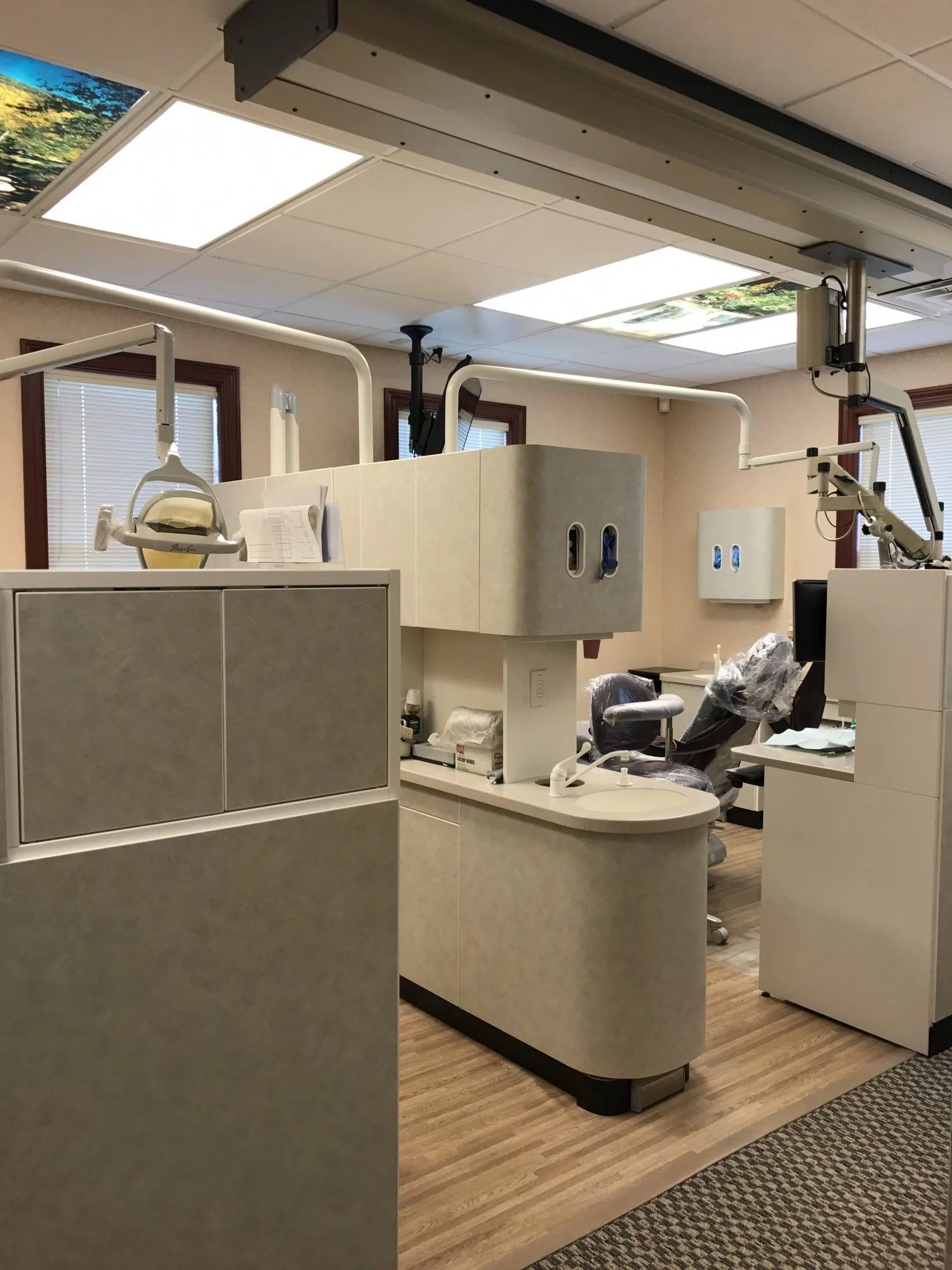 A treatment room with a dental chair and microscope